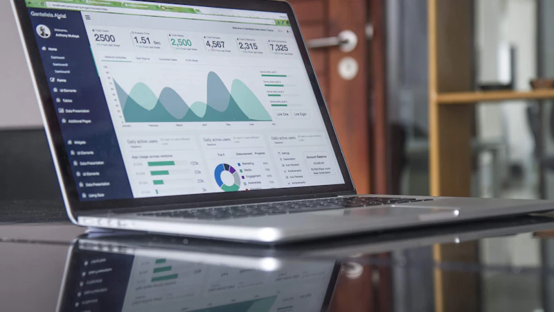 Laptop showing analytics charts on a glass table