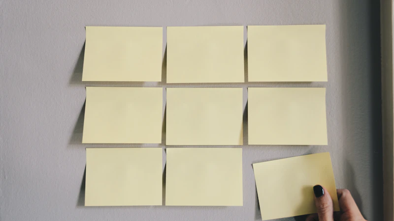 Six white sticky notes arranged on a wall