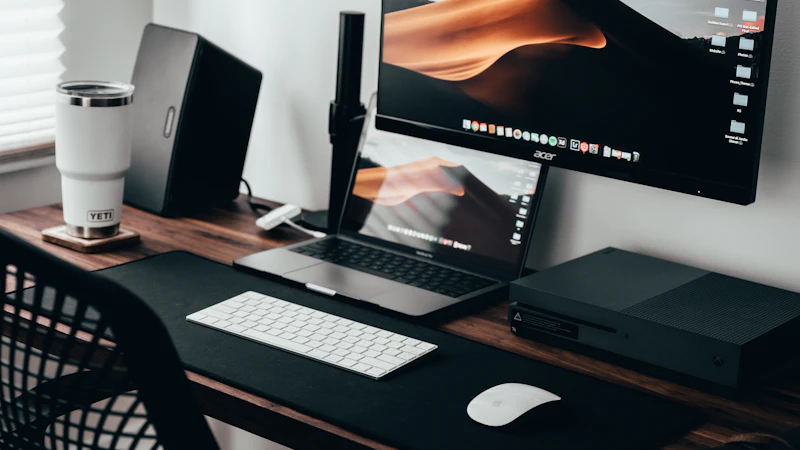 Home office workspace with a laptop, monitor and keyboard