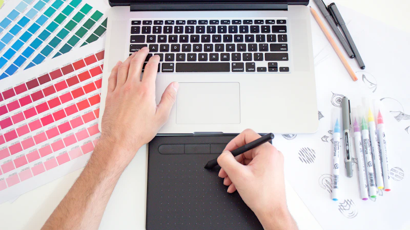 Designer using a drawing tablet with color swatches and markers