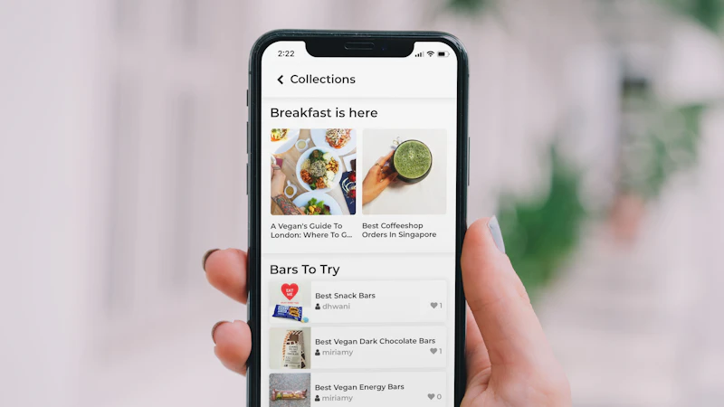 Hand holding a smartphone showing a food app