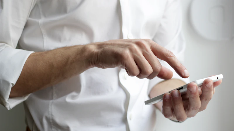 Person holding a white Android smartphone