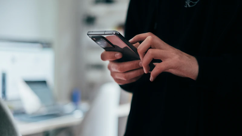Person holding a black Android smartphone