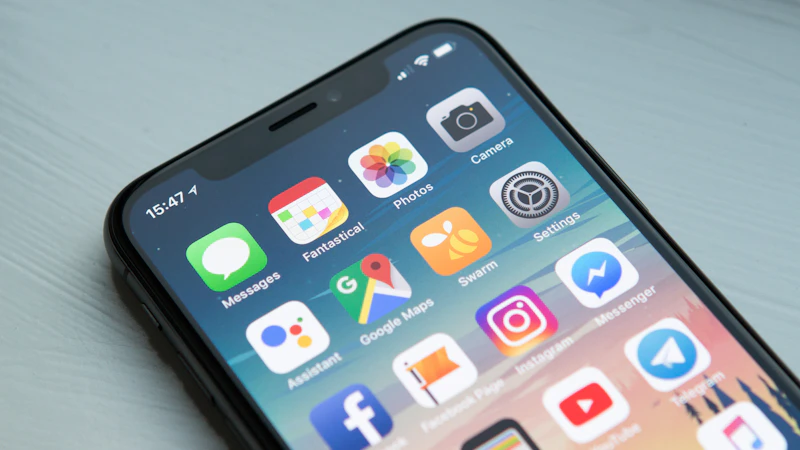 Space gray iPhone showing its home screen apps